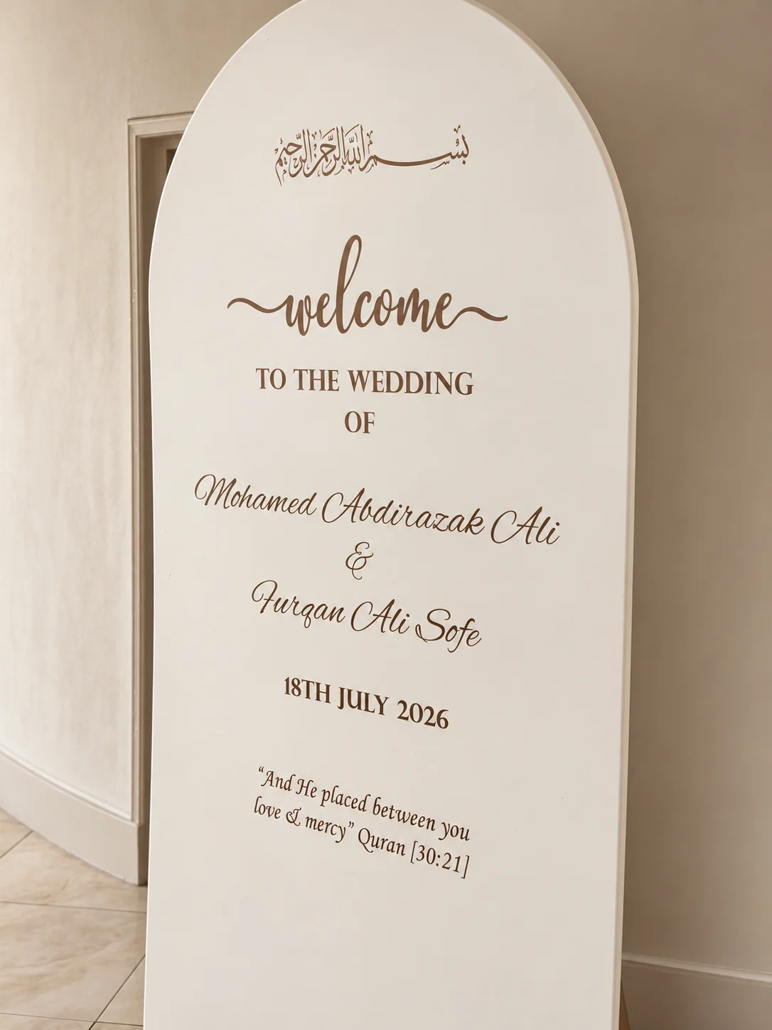 Arched wedding welcome board in a taupe and ivory colour treatment